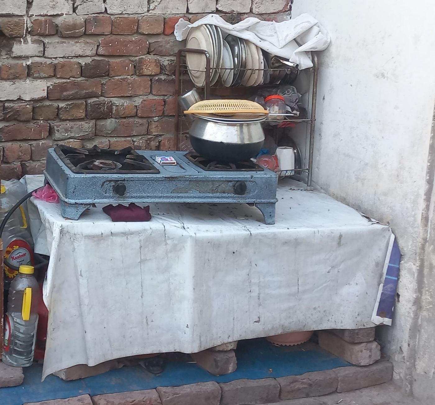 The current kitchen: a small stove on a table, outdoors